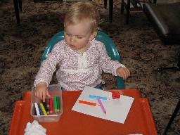 Ellie drawing at her plastic desk